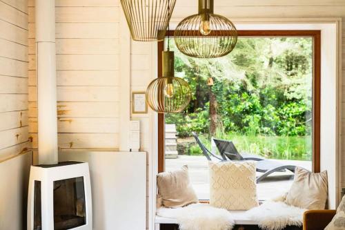 a living room with a couch and a tv at ZenCabin - Luxe en Wellness in de natuur in Hulshout