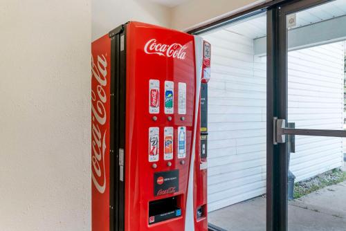 a coca cola vending machine next to a building at Econo Lodge Traverse City South in Traverse City