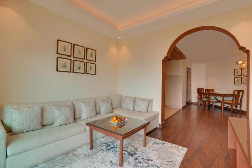 a living room with a couch and a table at Lemon Tree Resort, Mussoorie in Mussoorie