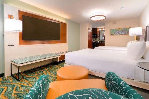 a hotel room with a large bed and a flat screen tv at Quality Inn Near the Island Pigeon Forge in Pigeon Forge