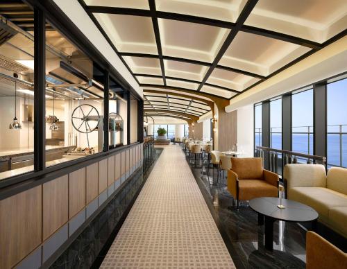 a lobby of a hotel with chairs and tables at Cassia Sokcho in Sokcho