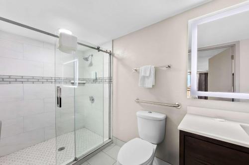 a bathroom with a shower and a toilet and a sink at Clarion Inn & Suites near the Leconte Center Pigeon Forge in Pigeon Forge