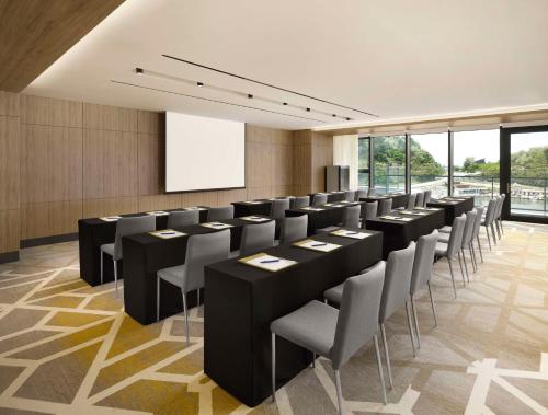 a conference room with black tables and chairs at Cassia Sokcho in Sokcho