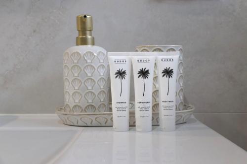 a group of three products sitting next to a bottle at Seaside Haven Tranquil Beachside Escape in Warriewood