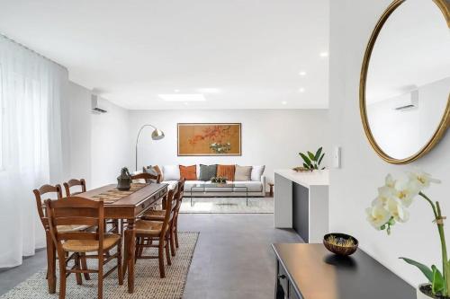 a dining room and living room with a table and chairs at Modern Balmain Abode in Sydney