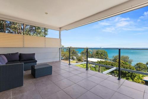 a living room with a view of the ocean at Breath taking Bay Views Private Pad Spacious in Morisset East