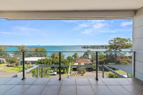 a view of the ocean from the balcony of a house at Breath taking Bay Views Private Pad Spacious in Morisset East
