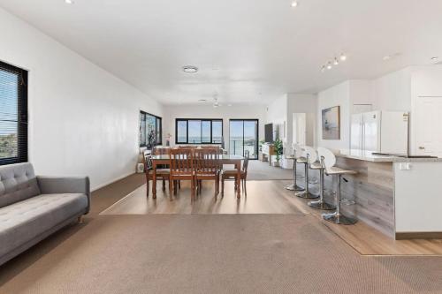 a kitchen and dining room with a table and chairs at Breath taking Bay Views Private Pad Spacious in Morisset East