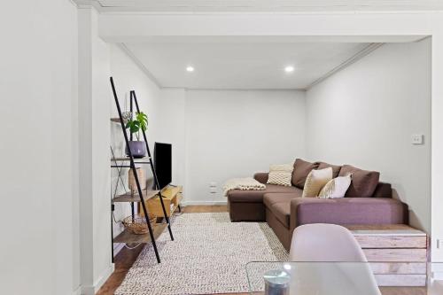 a living room with a couch and a table at Catalina Bay - Child & Pet Friendly in Rathmines