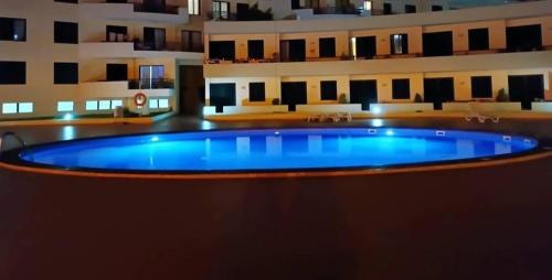 a large pool in the middle of a building at Estúdio Costinha - Madeira in Garajau