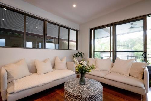 a living room with two couches and a table at The Emerald Bower in Rathmines