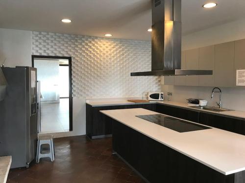 a kitchen with a sink and a counter top at Casa Vila Reyes in Sant Vicenç de Montalt