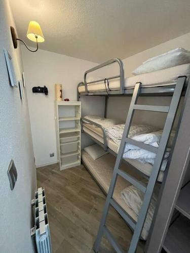 une chambre avec deux lits superposés et une échelle dans l'établissement Appartement pla d'adet aux pieds des pistes, à Cadeilhan-Trachère