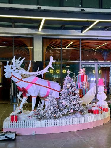 a statue of a reindeer and a christmas tree at Flamingo1 Ibiza Hai Tien in Nam Khê