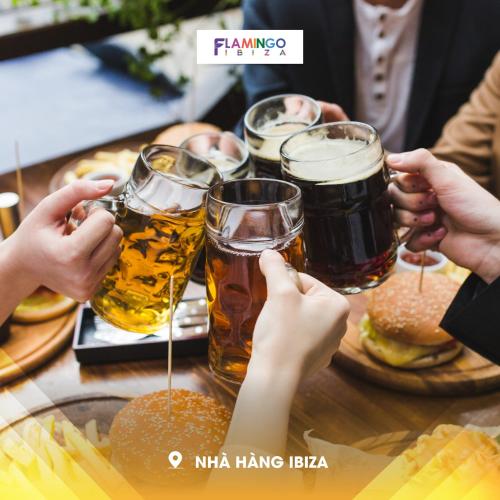 a group of people sitting around a table with glasses of beer at Flamingo1 Ibiza Hai Tien in Nam Khê