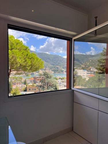 a bathroom with a large window with a view at La Loggia Sul Mare in Rapallo