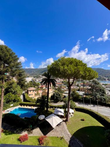 a view of a resort with a swimming pool and trees at La Loggia Sul Mare in Rapallo