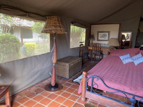 a bedroom with a bed in a tent at Buffalo's Rest Greenpark-Naivasha in Naivasha