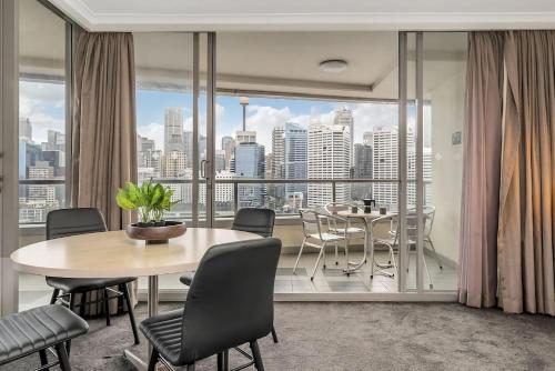 a dining room with a table and a view of the city at Dream Harbour View Parking Pool in Sydney