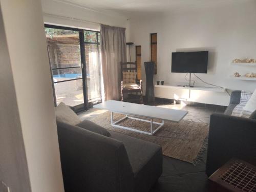 a living room with a couch and a table at Escape in Pretoria