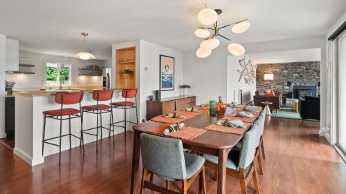 a dining room and kitchen with a table and chairs at Champ's Landing home in Colchester