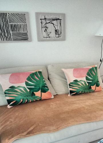 a couch with three pillows on top of it at Budget Suite Paranaque in Manila