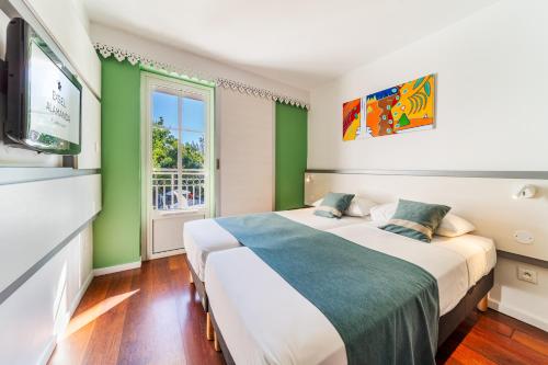 Postel nebo postele na pokoji v ubytování Hotel Exsel Alamanda