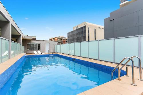 a swimming pool on the roof of a building at The Little Bondi Base in Sydney