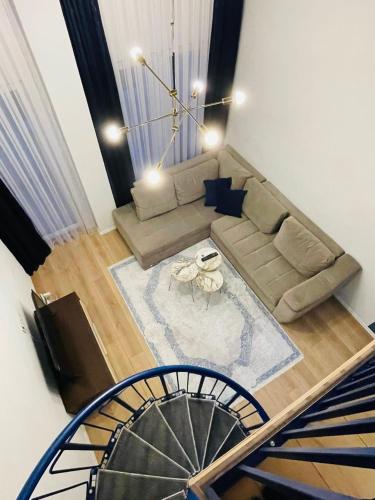 a living room with a couch and a table at Zen Apartments Pejë in Peje