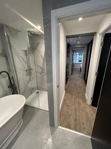 a bathroom with a shower and a tub and a toilet at 10 Hockenhall - Liverpool's Oldest House in Liverpool