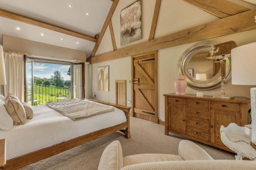 a bedroom with a large bed and a mirror at Hilltop View with Hot Tub in Brecon
