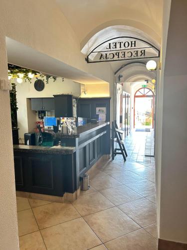 an entrance to a restaurant with a kitchen with a counter at Hotel Ambasadorski Rzeszów in Rzeszów