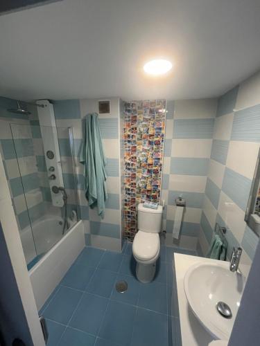 a bathroom with a toilet and a shower and a sink at Casa Venus in Algeciras