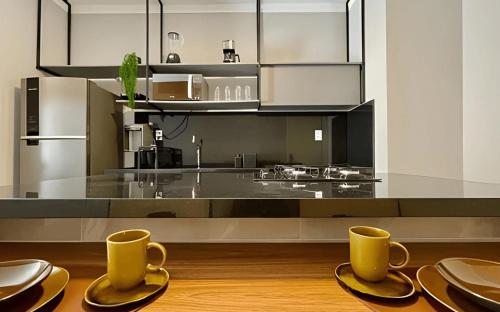a kitchen with two cups and plates on a table at MY STUDIO in Franca