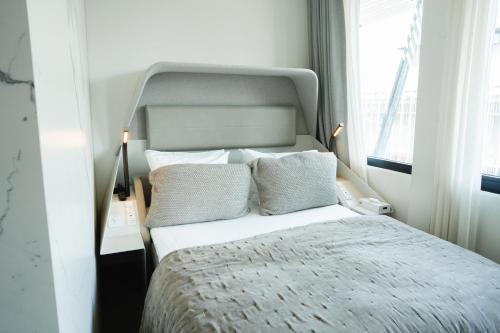 a bedroom with a bed with a large window at Boutique Hotel Herman K in Copenhagen