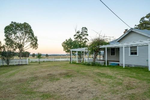 an empty yard in front of a white house at Janie s Cottage Secluded Wine Country Home in Broke