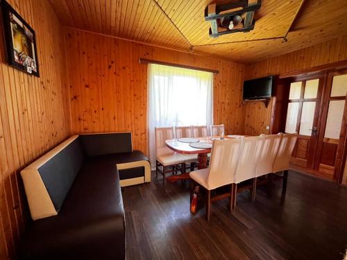 a dining room with a table and chairs at Карпатський двір in Krivorovnya