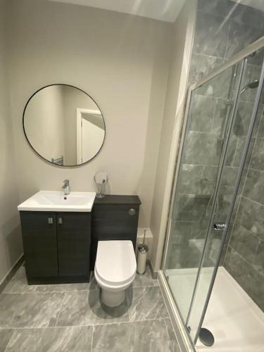 a bathroom with a toilet and a sink and a shower at Chic Mill conversion beside Piece Hall & Eureka! in Halifax
