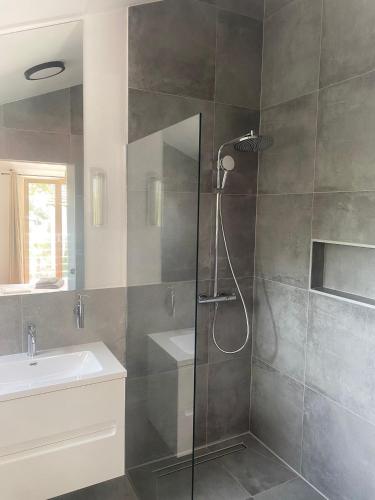 a bathroom with a shower and a sink at Villa Marumare in Milna