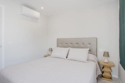 a white bedroom with a white bed with white pillows at Apartamento Brisa Marina in Arona