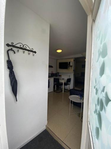 a hallway with an umbrella hanging on a wall at La Luna - Desi in Heerhugowaard