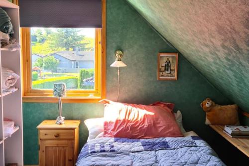 a bedroom with a bed and a window at Comfortable house with balcony&Terrace and view in Kopervik