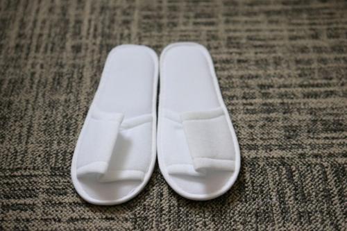 a pair of white shoes sitting on the floor at Almont Inn Shonan Fujisawa in Fujisawa