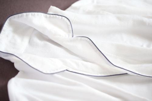 a close up of a white bedsheet at Almont Inn Shonan Fujisawa in Fujisawa
