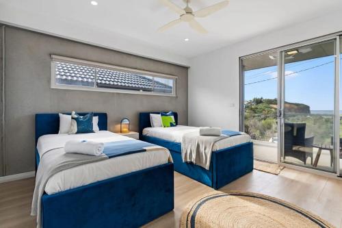 Ένα ή περισσότερα κρεβάτια σε δωμάτιο στο Exquisite Beachside Mansion