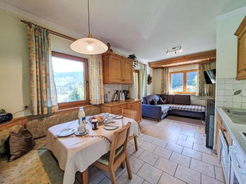 a kitchen and living room with a table and a couch at Apartment Hermine by Interhome in Auffach