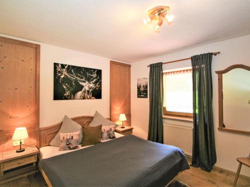 a bedroom with a bed and a mirror at Apartment Wandegg by Interhome in Ginzling