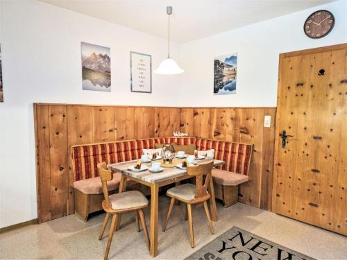 a dining room with wooden walls and a wooden table and chairs at Apartment Wandegg by Interhome in Ginzling