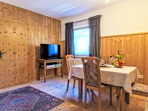 a dining room with a table and a television at Apartment Wandegg by Interhome in Ginzling