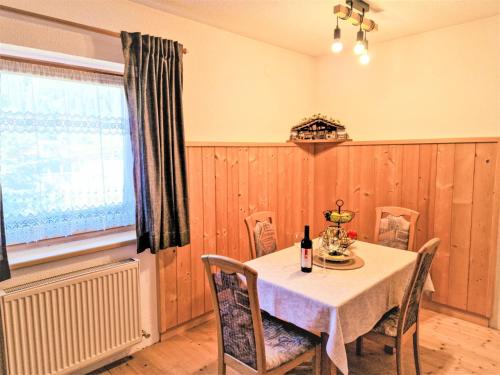 a dining room with a table and chairs and a window at Apartment Wandegg by Interhome in Ginzling